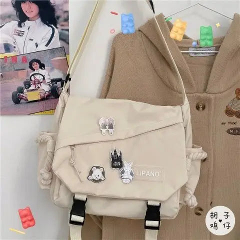 Preppy Style Pins-Decor Messenger Bag | Sophisticated Large-Capacity School Bag | Elegant Release-Buckle Flap Crossbody | "Dignified" Soft Nylon Satchel for Versatile Youth Styling Luxegan