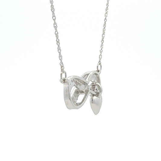 Colgante religioso de cruz con diamante de .04ct de plata de ley