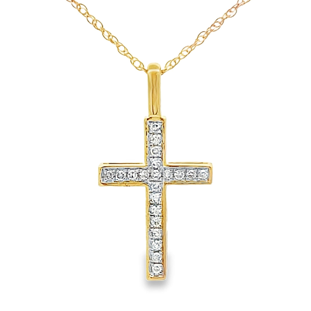 Colgante religioso de cruz con diamante de .07 ct en oro amarillo de 10 kt