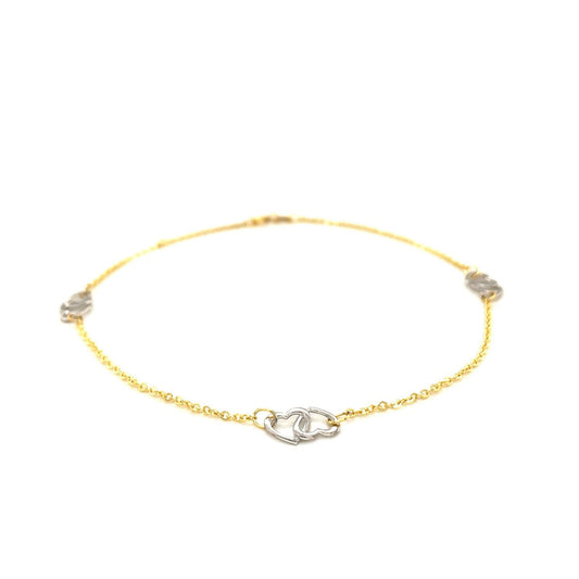 Tobillera con diseño de corazón entrelazado en oro bicolor de 14k