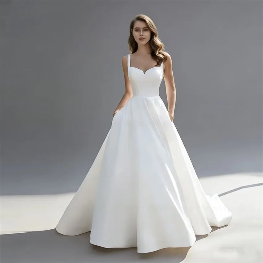 Elegant Satin A-Line Wedding Dress with Pockets | Minimalist V-Neck Spaghetti Strap Bridal Gown | Sexy Backless Floor-Length Bride Dress | Model 30249 Simple Custom Gown with Sweep Train Luxegan