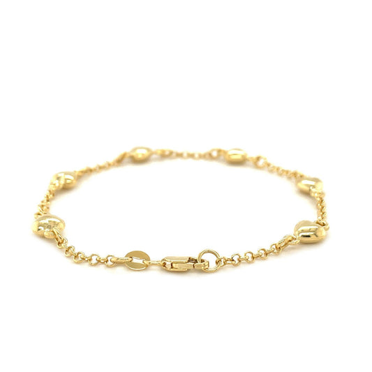 Pulsera de cadena Rolo de oro amarillo de 14k con estaciones de corazones inflados